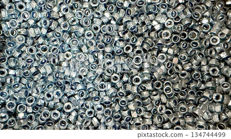 Mass production of metal fasteners as industrial manufacturing concept Mass production of metal fasteners as industrial manufacturing concept 134744499