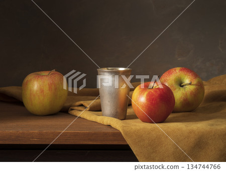 Still Life With Apples And Metal Cup On Wooden Table In Warm Rustic Setting 134744766