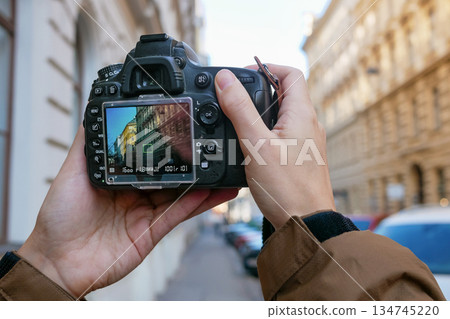Photographer Taking Urban Architecture Photo with DSLR Camera on City Street Photographer Taking Urban Architecture Photo with DSLR Camera on City Street 134745220