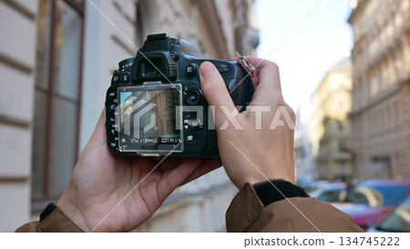 Photographer Taking Urban Architecture Photo with DSLR Camera on City Street Photographer Taking Urban Architecture Photo with DSLR Camera on City Street 134745222