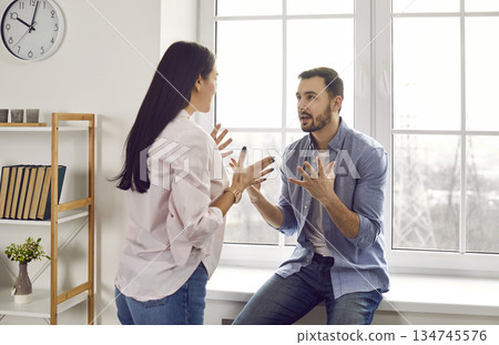 Young family couple having a disagreement, quarreling, and shouting at each other 134745576