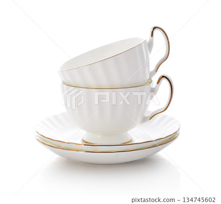 Two white golden rimmed porcelain tea cups with saucers Two white golden rimmed porcelain tea cups with saucers 134745602