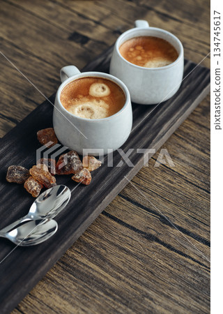 Two cups of coffee on wooden tray Two cups of coffee on wooden tray 134745617