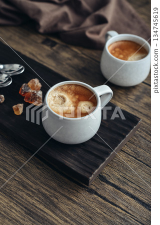 Two cups of coffee on wooden tray Two cups of coffee on wooden tray 134745619