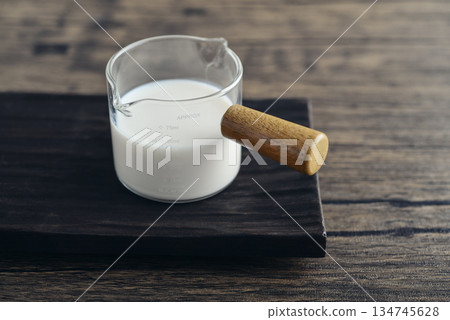 Milk in measuring glass cup 134745628