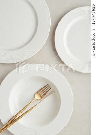 Clean plates, golden colored fork and knife Clean plates, golden colored fork and knife 134745629