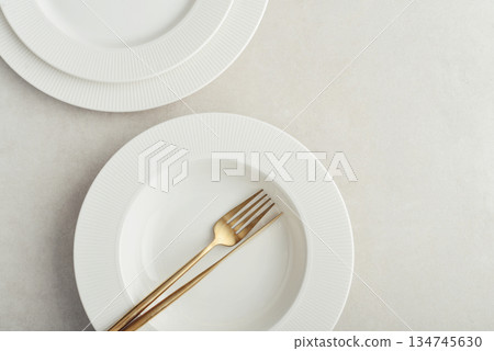 Clean plates, golden colored fork and knife Clean plates, golden colored fork and knife 134745630