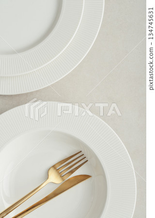 Clean plates, golden colored fork and knife Clean plates, golden colored fork and knife 134745631