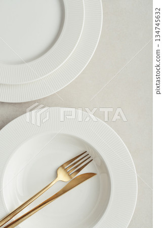 Clean plates, golden colored fork and knife Clean plates, golden colored fork and knife 134745632