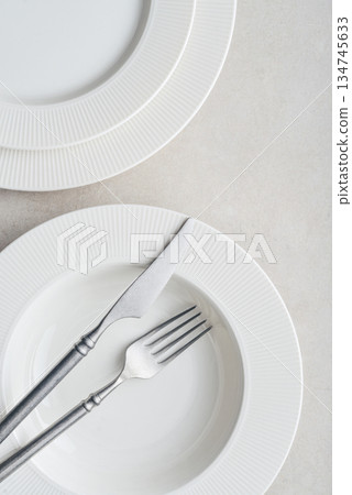 Clean plates, vintage fork and knife on light background 134745633