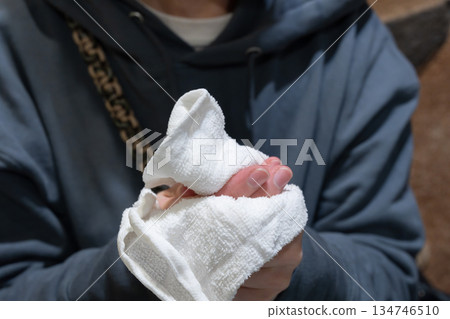 A person wiping their hands with a wet towel A person wiping their hands with a wet towel 134746510