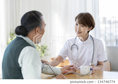 Medical staff measuring the blood pressure of a senior man 134746774
