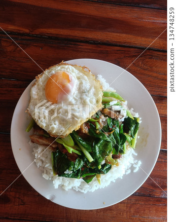 Fried egg rice pork basil vegetable, Thai street food lunch meal Fried egg rice pork basil vegetable, Thai street food lunch meal 134748259