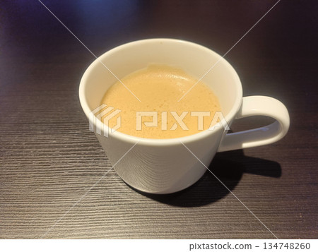 White cup coffee espresso froth ceramic mug drink on dark table White cup coffee espresso froth ceramic mug drink on dark table 134748260