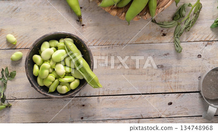 Fresh and raw green broad beans Fresh and raw green broad beans 134748968