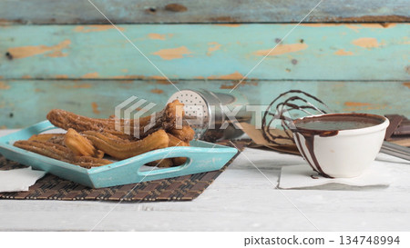 Traditional churros with hot chocolate 134748994