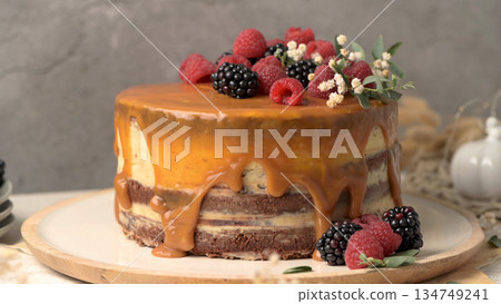 Layered Cake with Caramel Drip and Fresh Mixed Berries Layered Cake with Caramel Drip and Fresh Mixed Berries 134749241