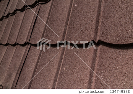 Brown Roof Tiles Close-up: Patterned Texture of Residential Roofing for Home Improvement and Construction Industry Concepts 134749588