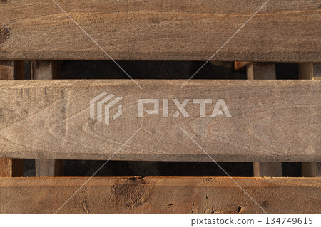 Rustic wooden pallet creating abstract patterns with natural light and shadow play, ideal for textured backgrounds and vintage design projects Rustic wooden pallet creating abstract patterns with natural light and shadow play, ideal for textured backgrounds and vintage design projects 134749615