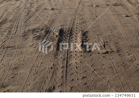 Tire Tracks on Dirt Road Surface Showing Tread Patterns and Textures for Transportation Concept or Off-Road Adventure 134749631