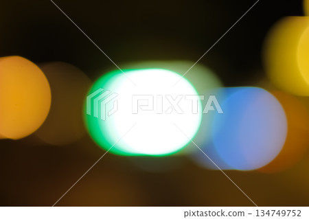 Abstract colorful blurred bokeh lights at night with slow shutter speed creating circular shapes ideal for festive backgrounds and wallpapers 134749752