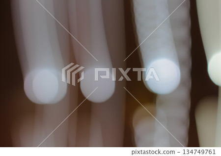 Blurred lights streak with slow shutter speed and lens blur effect, creating soft and dreamy visual background for atmospheric designs Blurred lights streak with slow shutter speed and lens blur effect, creating soft and dreamy visual background for atmospheric designs 134749761