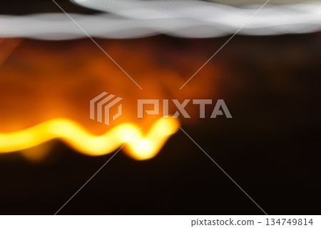 Abstract Light Trails with Slow Shutter Speed and Blur Effect, Featuring Vibrant Yellow and Orange Hues for Creative Design Projects Abstract Light Trails with Slow Shutter Speed and Blur Effect, Featuring Vibrant Yellow and Orange Hues for Creative Design Projects 134749814