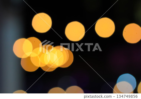Abstract golden bokeh lights shimmering on a dark background, creating a festive and magical atmosphere for celebration Abstract golden bokeh lights shimmering on a dark background, creating a festive and magical atmosphere for celebration 134749856
