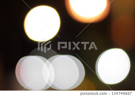 Abstract blurred bokeh of city lights at night creating a magical and dreamy atmosphere for festive backgrounds Abstract blurred bokeh of city lights at night creating a magical and dreamy atmosphere for festive backgrounds 134749887