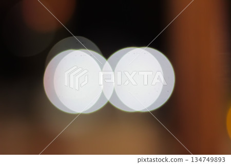 Abstract overlapping white bokeh circles on blurred background suggesting glowing lights for festive mood and dreamy, ethereal visual designs Abstract overlapping white bokeh circles on blurred background suggesting glowing lights for festive mood and dreamy, ethereal visual designs 134749893
