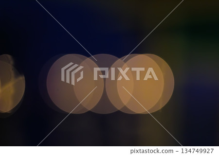 Abstract bokeh circles glowing softly on dark background creating a dreamy, ethereal mood, perfect for festive designs or a touch of magic 134749927
