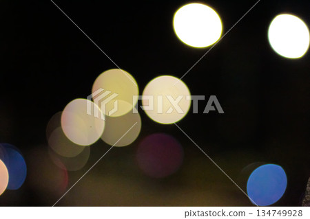 Abstract bokeh lights shimmering in the dark night, creating a soft, dreamy effect perfect for festive backgrounds or atmospheric designs 134749928