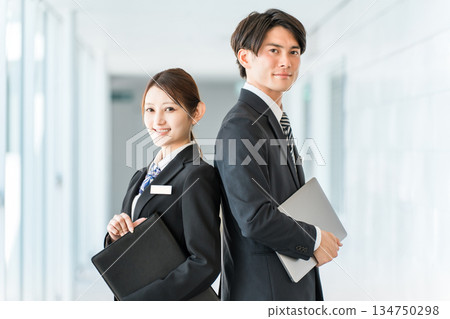 Young male and female Asian business people in suits (planner, advisor, banker, consultant) Young male and female Asian business people in suits (planner, advisor, banker, consultant) 134750298