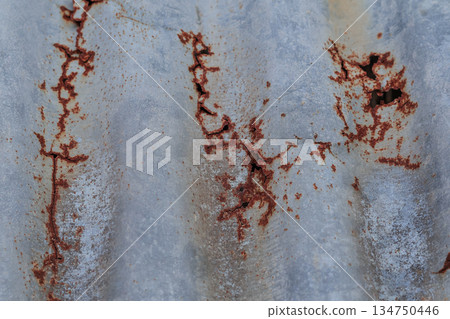Corrugated metal sheet with rust patterns creating abstract textures and grunge effects for industrial design elements Corrugated metal sheet with rust patterns creating abstract textures and grunge effects for industrial design elements 134750446
