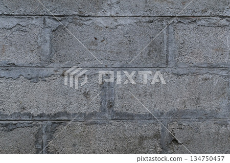 Concrete block wall providing a textured background with rough surfaces and visible mortar, ideal for construction or industrial concept 134750457