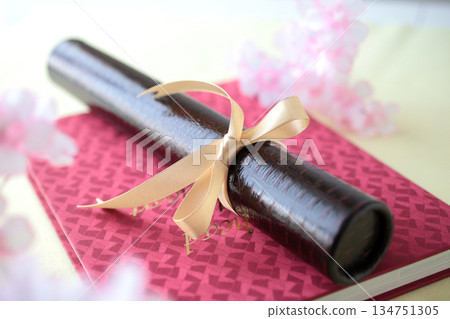 Diploma and cherry blossom petals Diploma and cherry blossom petals 134751305