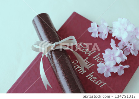 Diploma and cherry blossom petals Diploma and cherry blossom petals 134751312