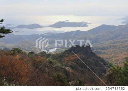 Shodoshima in late autumn, Utsumi Bay and Tanoura Peninsula seen from Kankakei Gorge with its autumn leaves Shodoshima in late autumn, Utsumi Bay and Tanoura Peninsula seen from Kankakei Gorge with its autumn leaves 134752362