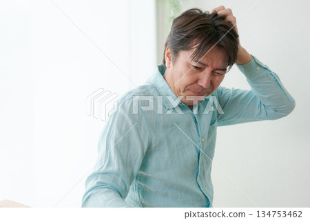 Man holding his head Man holding his head 134753462