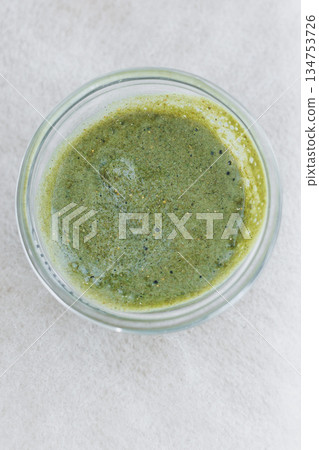 A Fresh Green Herbal Sauce beautifully packaged in a sleek Glass Container This capsulated flavor is sure to be a Vibrant Addition to All Your Culinary Creations and meal presentations A Fresh Green Herbal Sauce beautifully packaged in a sleek Glass Container This capsulated flavor is sure to be a Vibrant Addition to All Your Culinary Creations and meal presentations 134753726