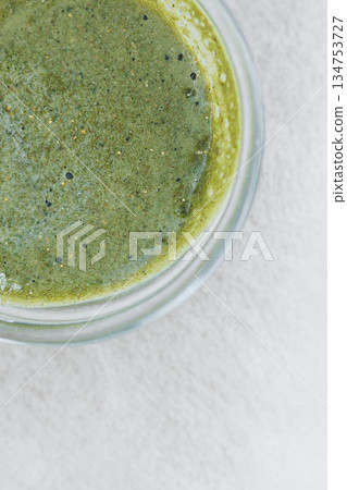 This refreshing green smoothie, served in a stylish jar, is a vibrant superfood drink that enhances your diet with delicious flavors, energizing your body and mind while providing essential nutrients This refreshing green smoothie, served in a stylish jar, is a vibrant superfood drink that enhances your diet with delicious flavors, energizing your body and mind while providing essential nutrients 134753727