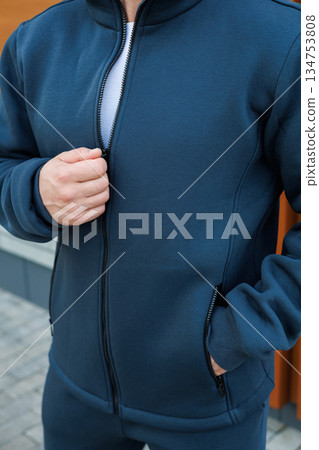 A Stylish Man is seen in a Modern Athletic Jacket posing confidently outdoors, set against a Trendy Urban backdrop, showcasing the essence of contemporary fashion and active lifestyle A Stylish Man is seen in a Modern Athletic Jacket posing confidently outdoors, set against a Trendy Urban backdrop, showcasing the essence of contemporary fashion and active lifestyle 134753808