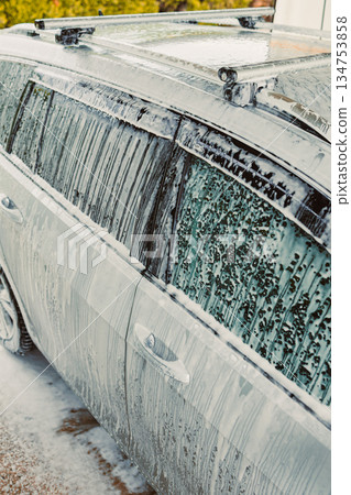 The Comprehensive Car Washing Process Involves Utilizing Foam and Water An SUV is Generously Covered in Soap to Achieve a Pristine Clean Finish That Everyone Desires After a Wash The Comprehensive Car Washing Process Involves Utilizing Foam and Water An SUV is Generously Covered in Soap to Achieve a Pristine Clean Finish That Everyone Desires After a Wash 134753858