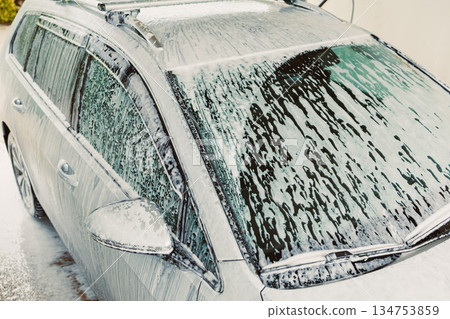 The Car Wash Process Involves Carefully Applying Soap Foam to the Vehicle During a Thorough and Comprehensive Cleaning Session to Ensure a Sparkling Clean and Absolutely Spotless Finish for the Car The Car Wash Process Involves Carefully Applying Soap Foam to the Vehicle During a Thorough and Comprehensive Cleaning Session to Ensure a Sparkling Clean and Absolutely Spotless Finish for the Car 134753859