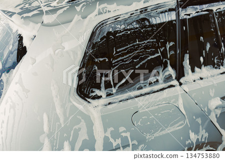 The Car Wash Process involves applying fresh soap and foam thoroughly on the vehicles surface to ensure that it is clean and free of dirt, leaving it sparkling and looking brand new 134753880