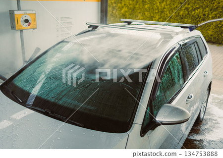 The Car Wash in Action A Silver Vehicle Undergoing an Intensive Cleaning Process at a StateoftheArt SelfService Car Wash Station, Ensuring Every Detail is Perfectly Cleaned and Shiny The Car Wash in Action A Silver Vehicle Undergoing an Intensive Cleaning Process at a StateoftheArt SelfService Car Wash Station, Ensuring Every Detail is Perfectly Cleaned and Shiny 134753888