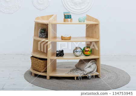 A wooden shelf with a cute piggy bank elegantly placed on top 134753945