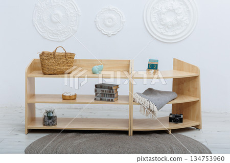 A Modern Wooden Shelf Featuring Beautiful Decorative Items in a Stylish Studio Space A Modern Wooden Shelf Featuring Beautiful Decorative Items in a Stylish Studio Space 134753960