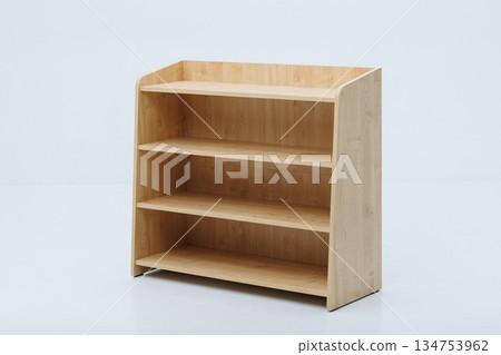 A wooden shelf that features three shelves set against a white background A wooden shelf that features three shelves set against a white background 134753962