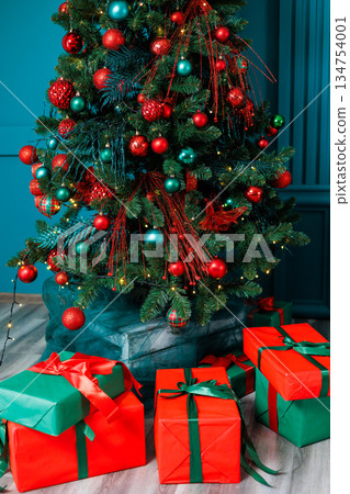 A cheerful Christmas scene features a beautifully decorated tree with glittering lights and colorful presents, creating a joyful atmosphere of celebration and warmth that fills the air A cheerful Christmas scene features a beautifully decorated tree with glittering lights and colorful presents, creating a joyful atmosphere of celebration and warmth that fills the air 134754001